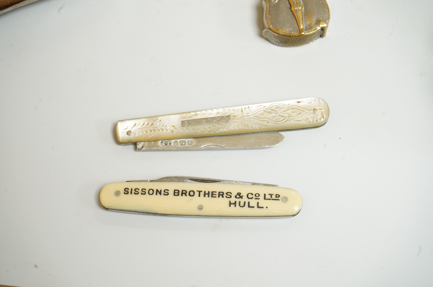 A small group of silver and other items, including an Edwardian silver mounted Common Prayer book(a.f.), a silver mounted matches holder, a silver mounted glass inkwell, a silver and mother of pearl fruit knife, two thim